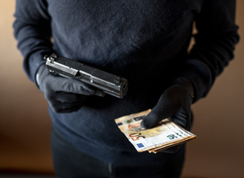 Normal_closeup-of-the-hands-of-a-robber-with-a-gun-and-a-2023-11-27-05-03-35-utc